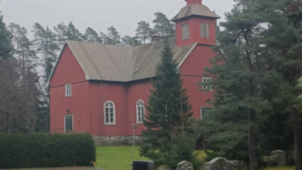 Puukirkko sumuisella vanhalla hautausmaalla.