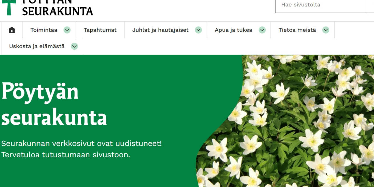 Valkovuokkoja ja vihreällä pohjalla tekstiä.